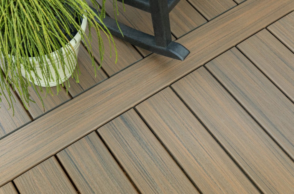 Premium composite deck boards installation showing natural wood texture