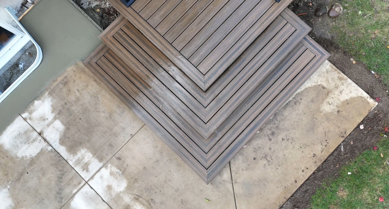 Natural wood deck installation with herringbone pattern detail